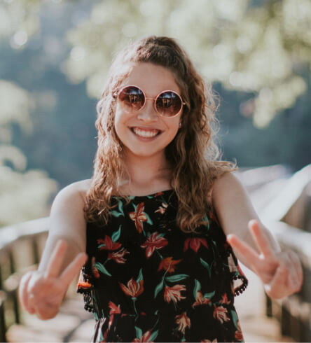 Smiling woman giving peace sign